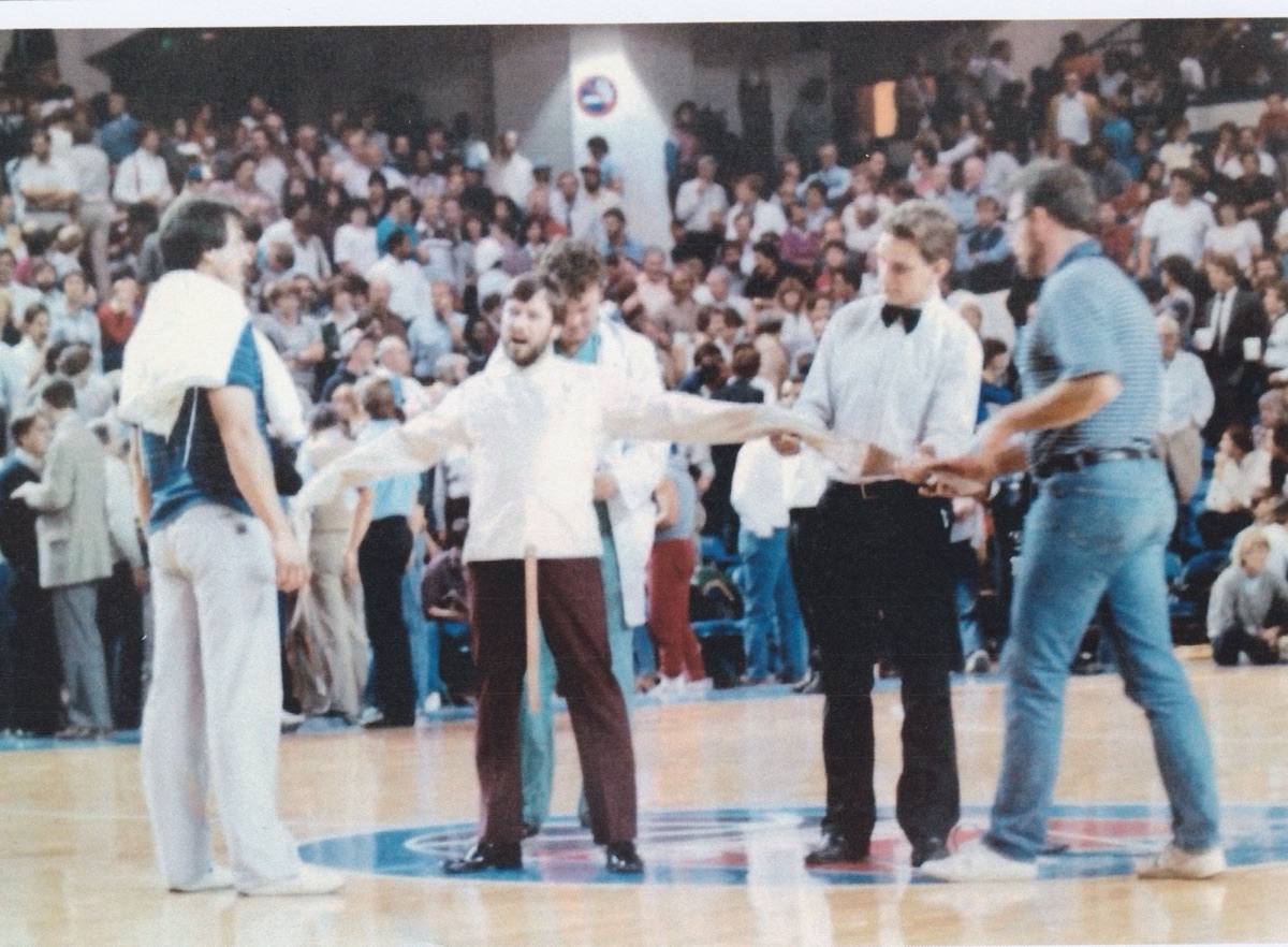 Halftime at ARCO Arena, October 31, 1985. Two men from the crowd strap me into the straitjacket.